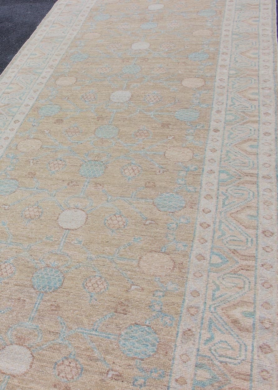 Pomegranate Khotan Design Long Runner in Soft Gold & L. Blue & Geometric Border. Long Khotan runner in Pomegranate Khotan Design, rug MP - 1910 - 10524, country of origin / type: Afghanistan / Khotan This Khotan features a geometric all - over Pom... - Keivan Woven ArtsMP - 1910 - 10524 - 12222Rug