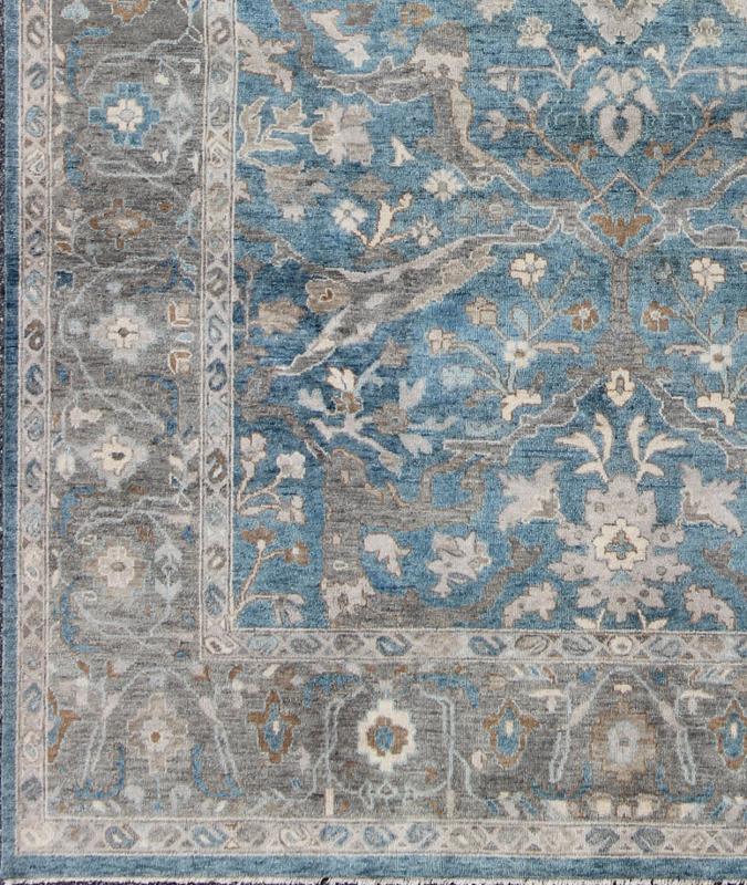 Blue and Gray Vintage Oushak Rug. Measures: 9' x 12'. This vintage Oushak carpet from Turkey features a all over traditional Oushak design rendered in tones of blue and gray, set atop a blue background. The central field features floating motifs ... - Keivan Woven ArtsOB - 9458373 - 06470003 - 8175Rug