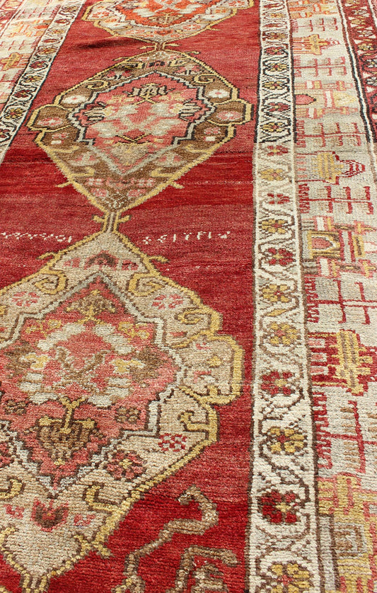 Antique Turkish Oushak Runner In Red Background with Neutral Medallions Measures: 3.11 x 9.0 This colorful Oushak carpet rests beautifully upon a field of elegant red. A large medallion of brown, taupe, yellow and gray takes center s... - Keivan Woven ArtsOSM - 02 - 4494