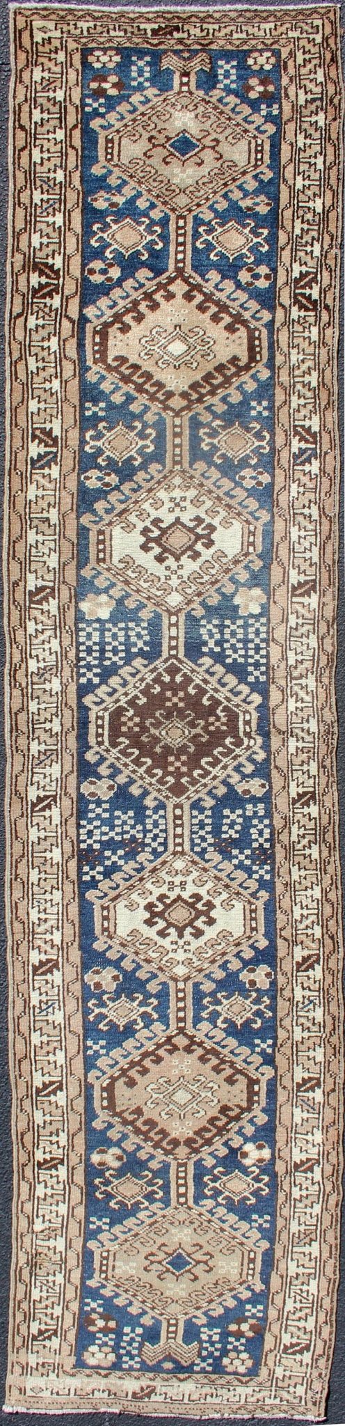 Antique Blue Tribal Karajeh Runner With Navy Blue, Brown and Earth Tones. Antique Persian Karajeh runner with stacked medallion in taupe, cream, blue, rug PRM - M522, country of origin / type: Iran / Karajeh , circa 1920 This antique Persian k... - Keivan Woven ArtsPRM - M522 - 12609Rug