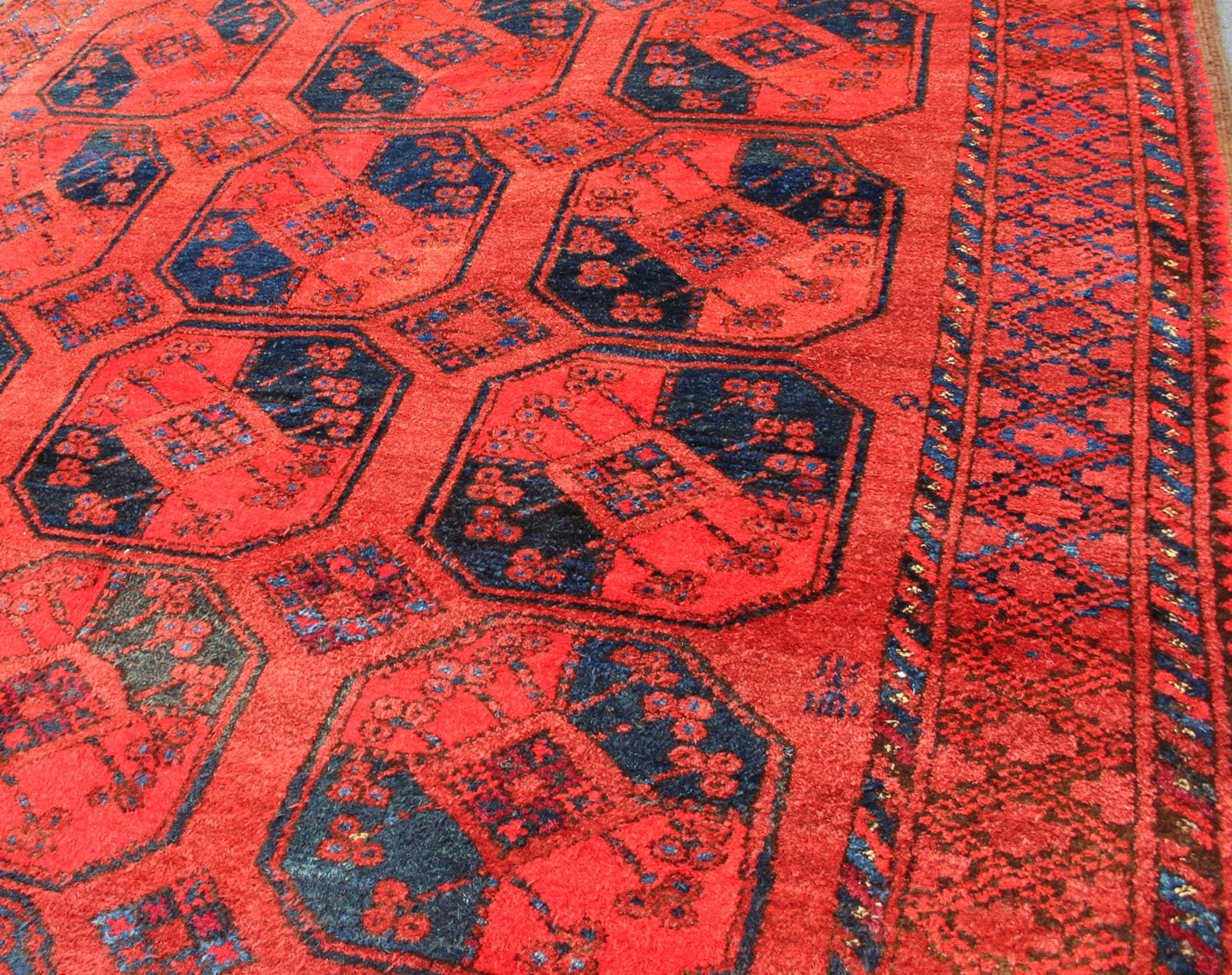 Ersari rug Medium sized hand - knotted rug with a red background with navy blue accents, cased within an intricate border and Gul design within the field. Circa 1940, Turkomen sub geometric, Keivan Woven Arts, rug R20 - 0604 Measurement 7'3... - Keivan Woven ArtsR20 - 0604 - 12946Rug