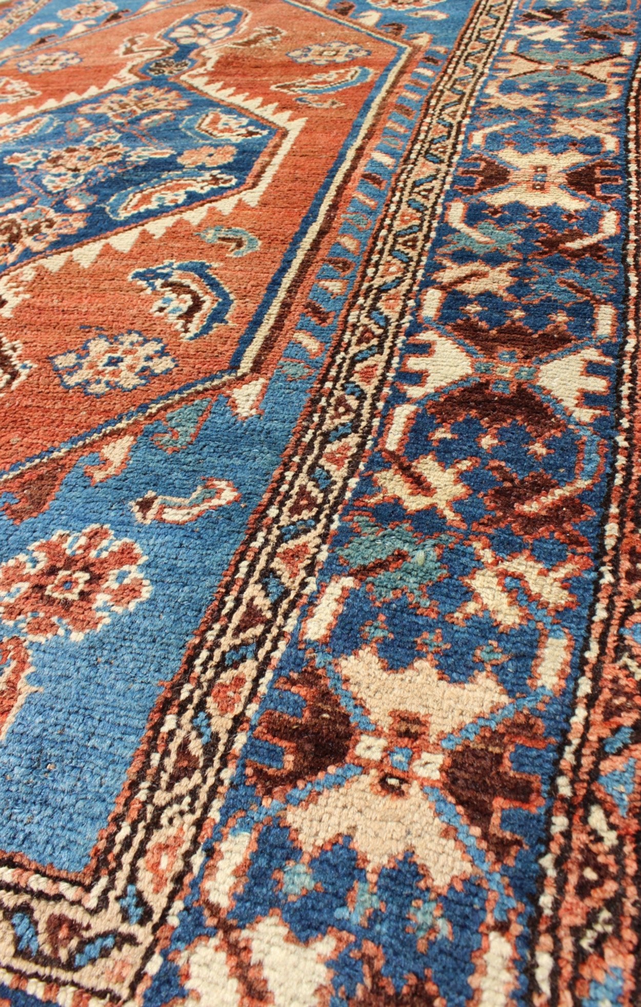 Antique Persian Karadjeh rug with tribal medallion in rust red and bright blue, rugs 12 - 0104, country of origin / type: Iran / Karadjeh, circa 1910. This early 20th century, handwoven antique Persian Karadjeh rug features a rust red - colored fiel... - Keivan Woven ArtsS12 - 0104 - 3223Rug