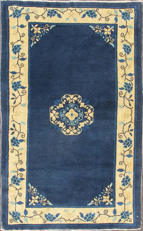 Antique Chinese Peking Carpet The saturated blue field of this piece forms a vibrant backdrop for a medallion with four - corner lotus blossom flowers, which were symbols of purity and spirituality in Buddhist traditions. An unusual interlocking f... - Keivan Woven ArtsS12 - 0510 - 3245