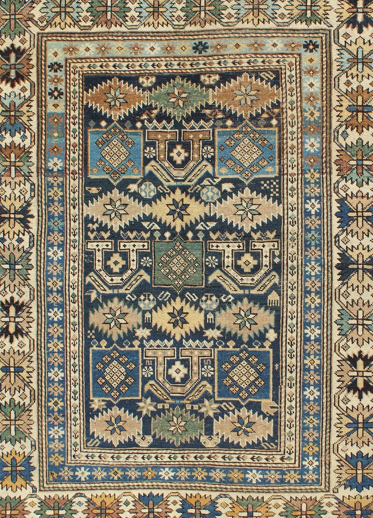 Antique Hand Knotted Caucasian Shirvan Rug in Blue with Tribal Design Measures: 3'3'' x 4'5''. The field of this Caucasian piece features all - over tribal motifs and shapes decorated with small flowers and square designs, alternating c... - Keivan Woven ArtsS12 - 0912 - 3670Rug