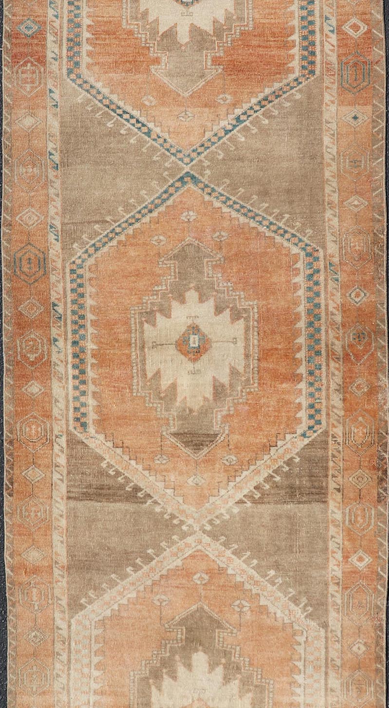 Measures: 3'6 x 13'0 Keivan Woven Arts Oushak Runner With Tribal and Geometric Motifs. Keivan Woven Arts / rug/SNK - 300, country of origin / type: Turkey / Oushak, circa 1940 This vintage runner features an assortment of tribal and geometric meda... - Keivan Woven ArtsSNK - 300 - 27658Rug
