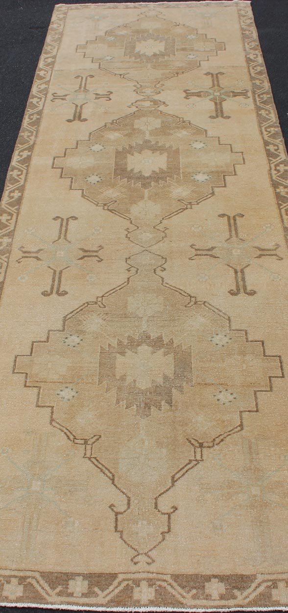 Vintage Turkish Oushak Runner Neutral and warm Colors with Tribal Medallions. wide and long vintage Turkish Oushak runner in neutral colors with medallions in taupe, blue and light brown. rug/TU - ALK - 4873. Vintage Oushak runner This vintage Ousha... - Keivan Woven ArtsTU - ALK - 4873 - 12126Rug