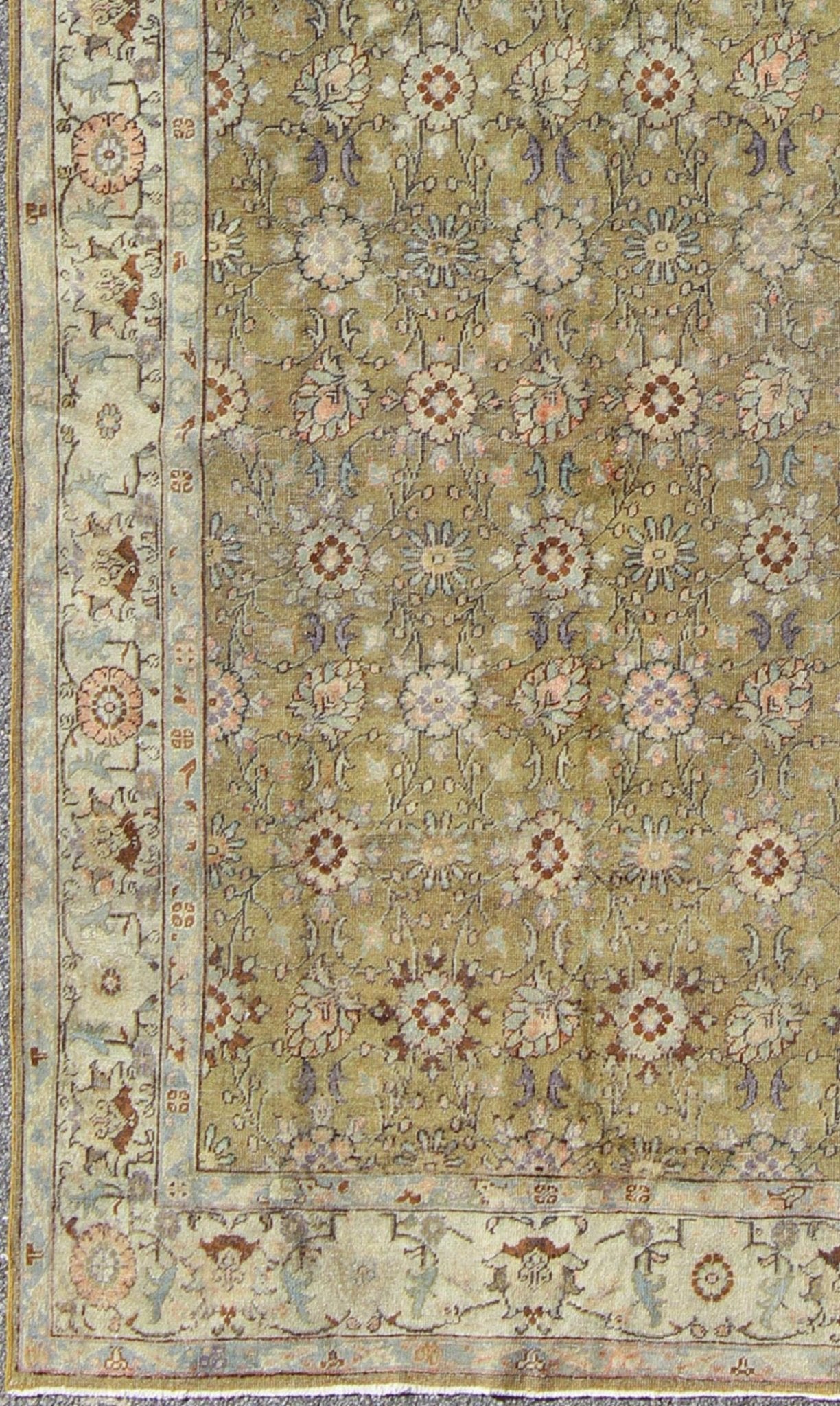 This broad antique Turkish Oushak runner is remarkably elegant in both color and design. The central field of olive green plays host to a variety interconnected blossoms in an all - over pattern with intermixed palmette motifs. The simplified inner and o... - Keivan Woven ArtsTU - CUM - 148 - 2400Rug