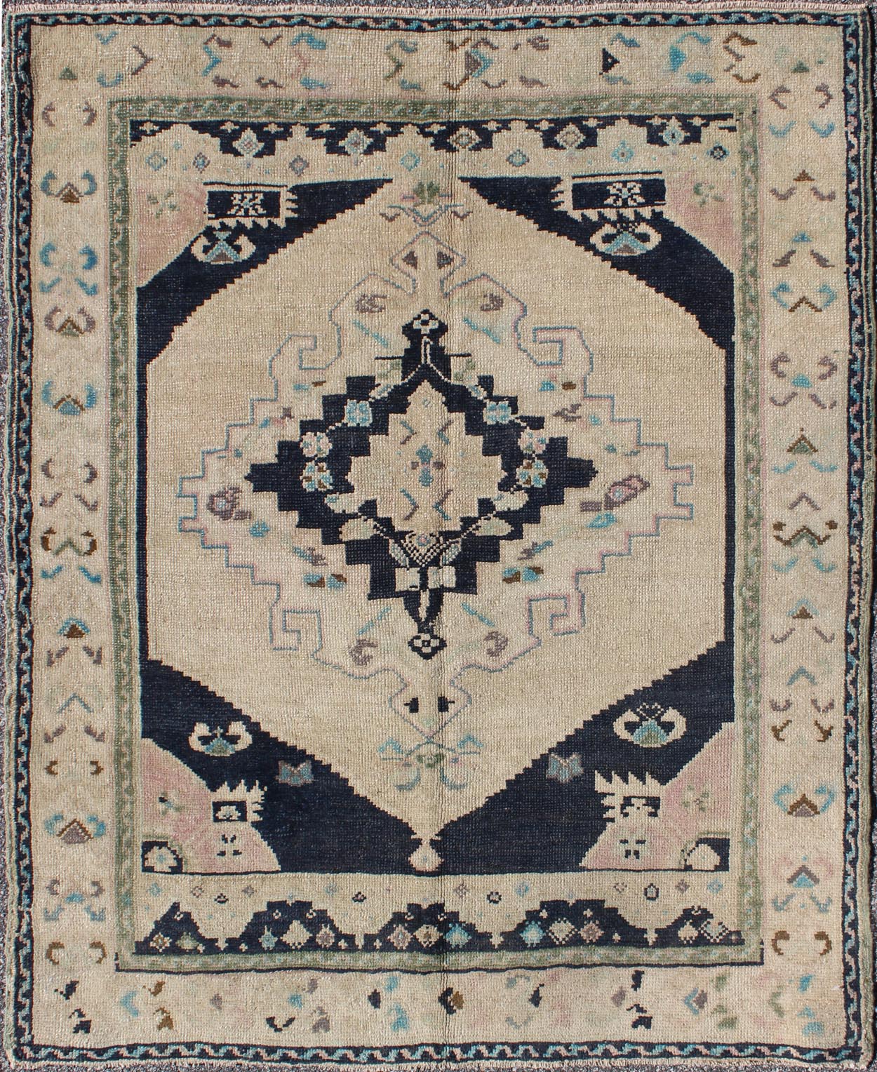 Vintage Hand Knotted Turkish Oushak Rug with Central Medallion in Cream and Blue This beautiful rug from mid - 20th century Turkey features a medallion with floral motifs surrounding it. The cream ground is home to the center medallion. Four dark ... - Keivan Woven ArtsTU - DUR - 3693 - 7903Rug