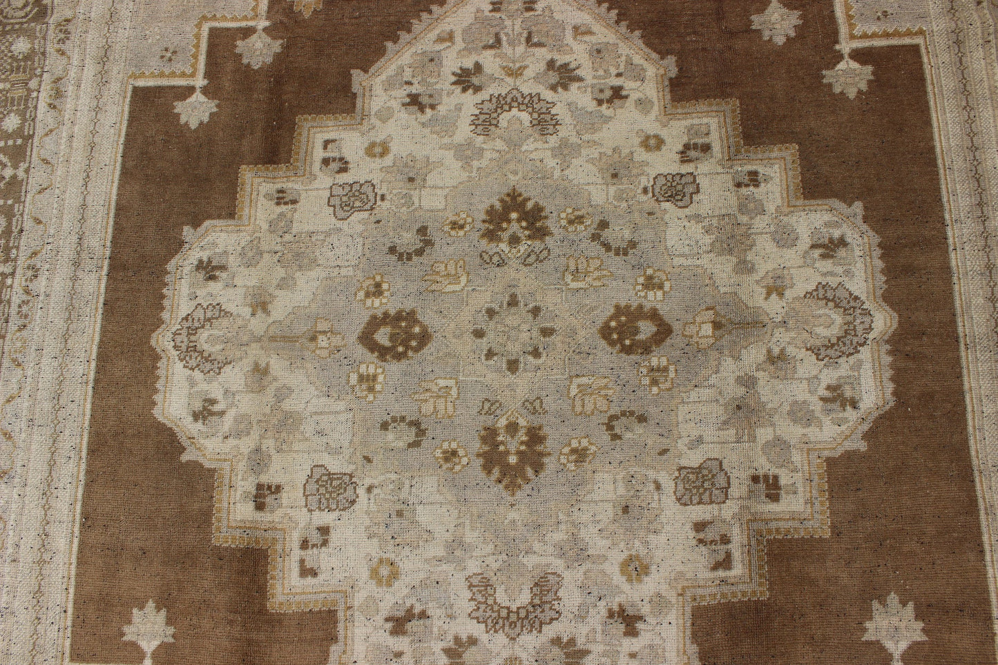 Vintage Turkish Oushak Rug in Brown Background and Neutral Colors Measures: 7'4 x 11'4 This lovely Turkish Oushak from the 1940's features a central medallion, which rests on a dark brown background, is surrounded by a light brown bor... - Keivan Woven ArtsTU - DUR - 506 - 3502Rug
