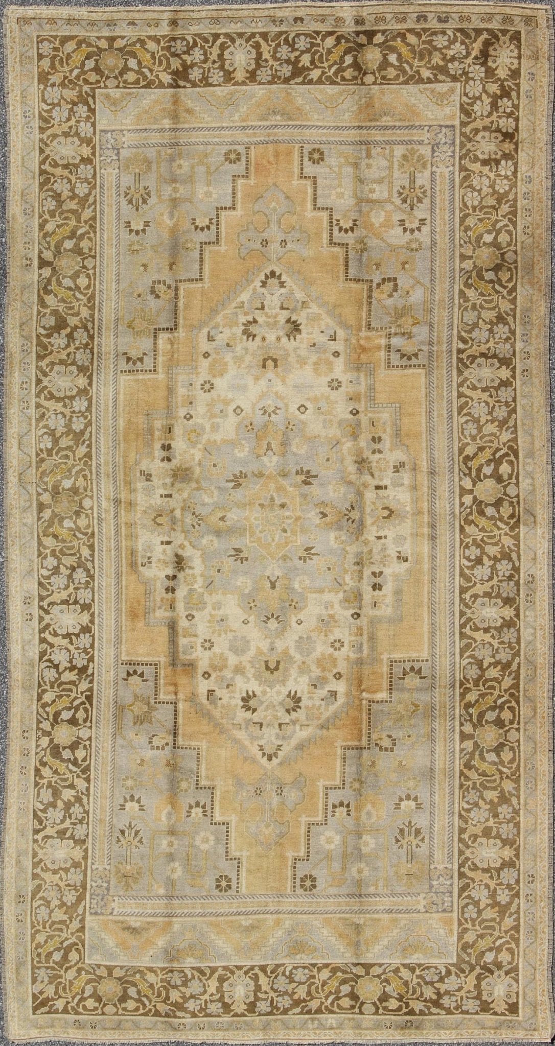 Vintage Turkish Medallion Oushak Rug in Gold, Taupe, Cream and Cocoa Measures: 6'8 x 12 This vintage Turkish Oushak features a bold design softened by unique, light tones. The border is chocolate brown and contains vines and flowers. Co... - Keivan Woven ArtsTU - DUR - 507 - 3508Rug