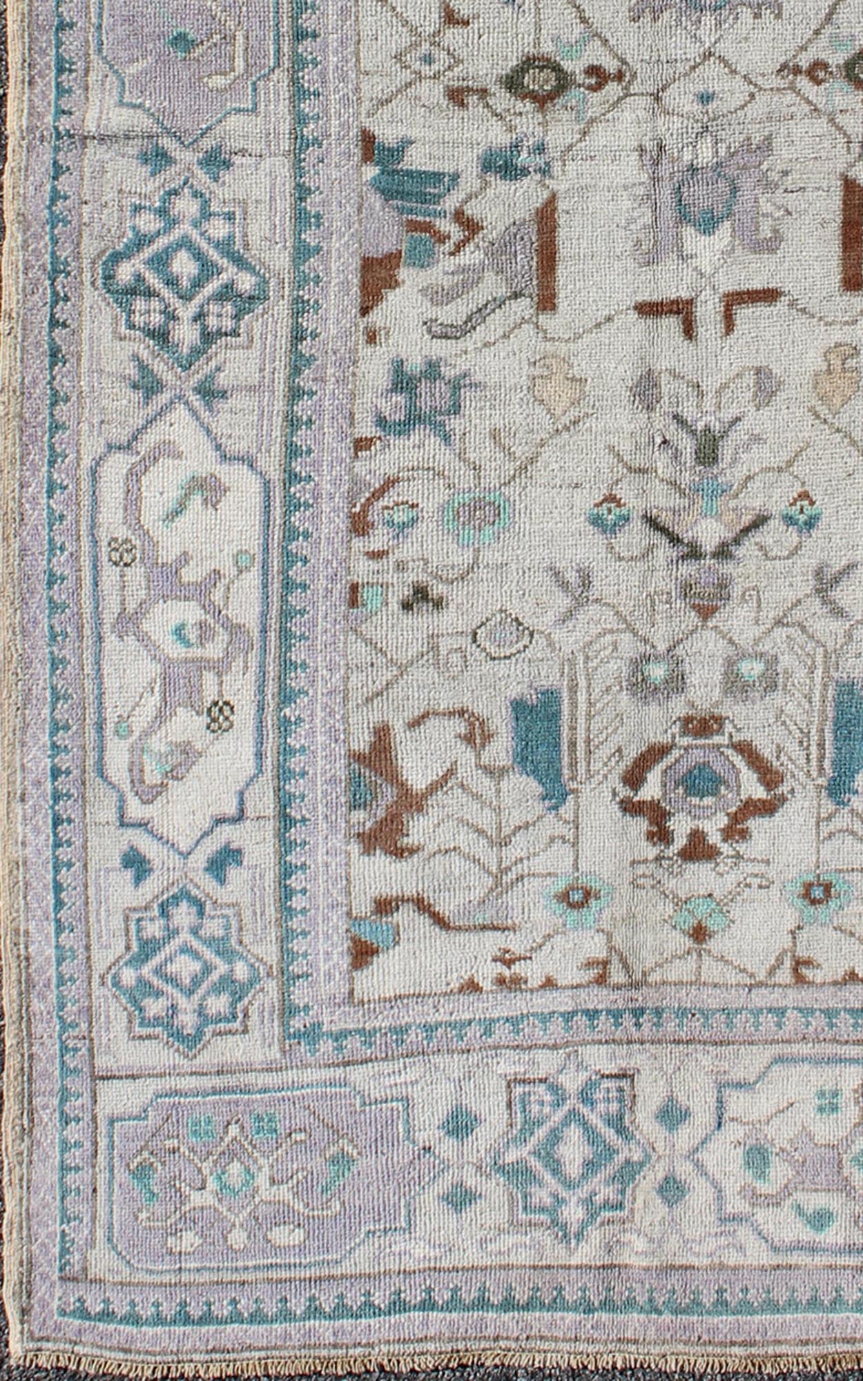 Vintage All - Over Floral Turkish Oushak Area Rug in Cream, Blue, Lilac and Red Measures: 4'4 x 8 This vintage Turkish Oushak carpet (circa mid - 20th century) features an all - over design of sub - geometric floral motifs atop of a creamy backgr... - Keivan Woven ArtsTU - IHS - 123347 - 3638Rug