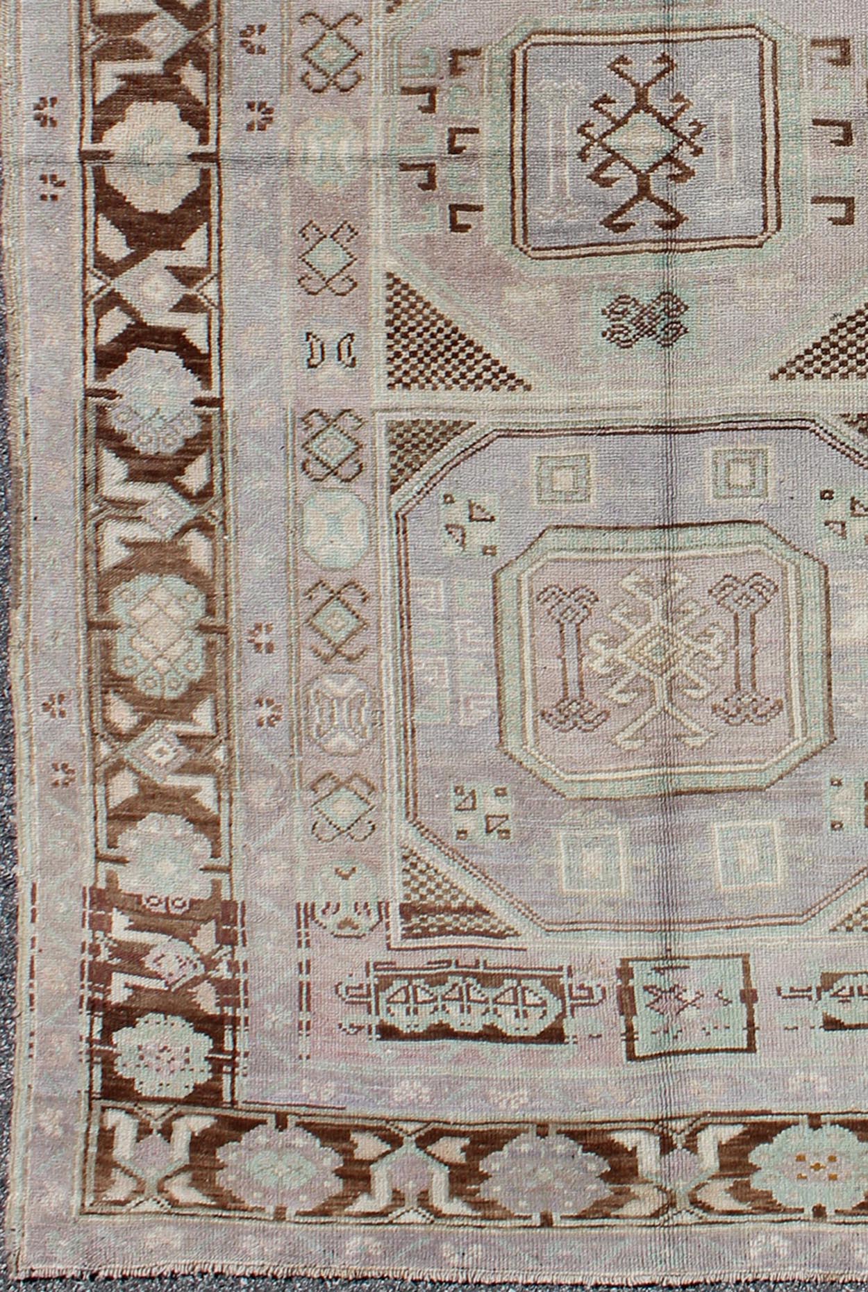 Lavender and teal vintage Turkish Oushak rug with tribal / geometric medallions. Keivan Woven Arts / rug TU - IHS - 95156, country of origin type: Turkey Oushak, circa mid - 20th century The lavender background of this vintage Oushak rug from Turkey (... - Keivan Woven ArtsTU - IHS - 95156 - 4554Rug