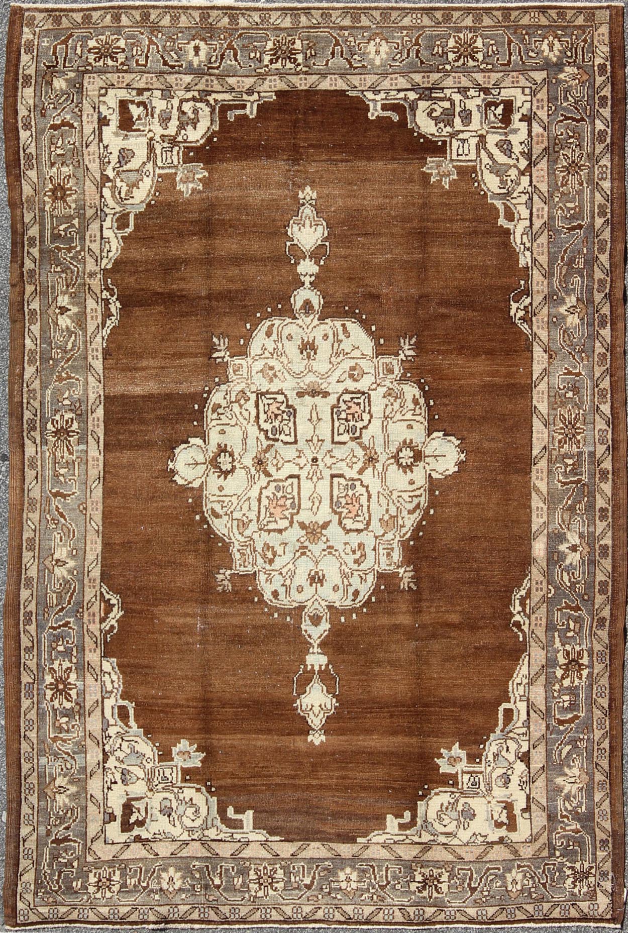 Vintage Turkish Oushak Rug with Floral Motifs in Chocolate Brown, Ivory, Taupe: This beautiful rug from early 20th century Turkey features a Classic Oushak design, which is enhanced by lustrous wool. The chocolate - brown ground is home to the centre med... - Keivan Woven ArtsTU - ISA - 136544 - 5241Rug