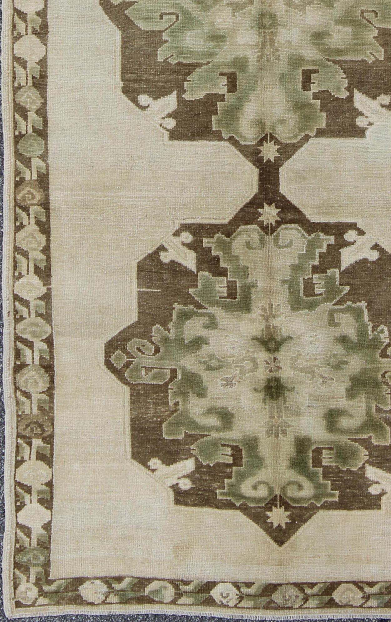 Green Turkish Oushak Runner This lovely Oushak runner displays three elegant medallions of multi - green colors on a solid cream field. The variety of green colors includes olive green, crocodile green and seaweed green. The minimal border coordin... - Keivan Woven ArtsTU - ISA - 3362 - 5740Rug