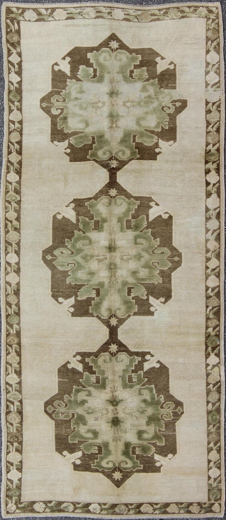 Green Turkish Oushak Runner This lovely Oushak runner displays three elegant medallions of multi - green colors on a solid cream field. The variety of green colors includes olive green, crocodile green and seaweed green. The minimal border coordin... - Keivan Woven ArtsTU - ISA - 3362 - 5740Rug