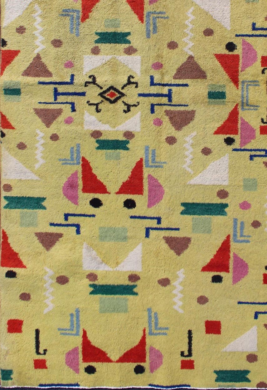 Mid Century Modern Vintage Turkish Rug in Yellow Background and Multi - Colors Measures: 4' x 7'10. Rendered in a yellow background with a spotted and speckled assortment of yellow, red, black, green and blue colors, this very unique Mid - Century r... - Keivan Woven ArtsTU - MTU - 05 - 5319Rug