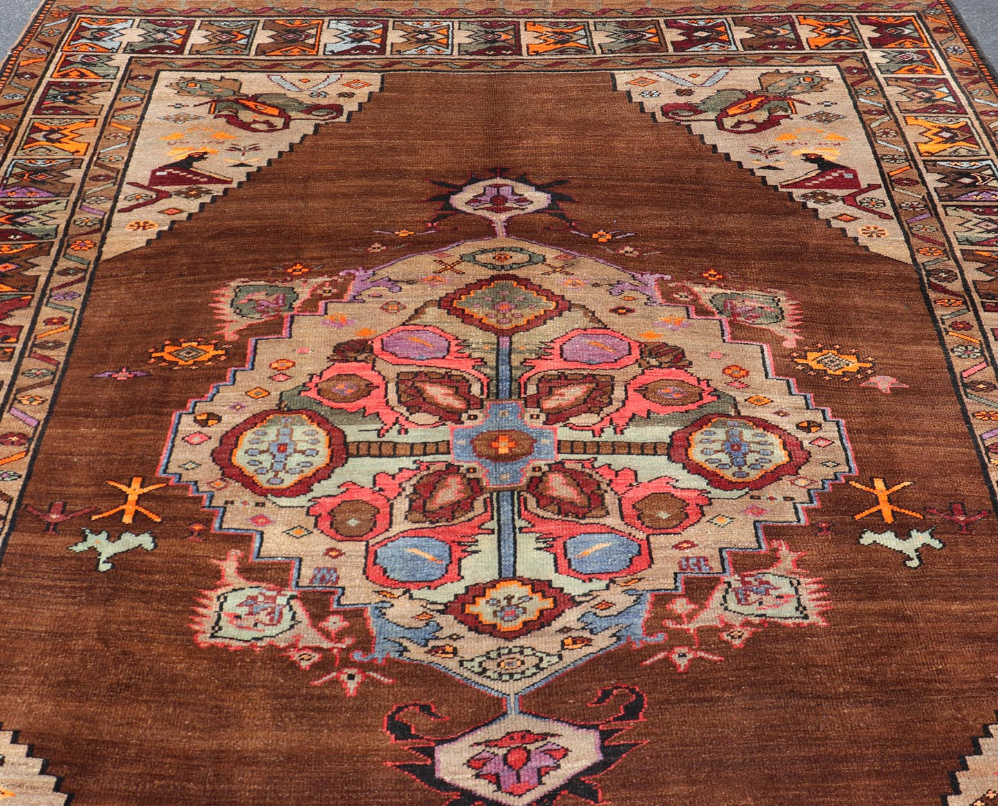 Vintage Turkish Kars Rug With Medallion On A Brown Field with Pops of Color. Keivan Woven Arts / rug/ TU - MTU - 3489, country of origin / type: Turkey / Oushak / Kars, circa 1940 Measures: 9'4 x 10'2. This Turkish Kars rug has been handwoven in Turk... - Keivan Woven ArtsTU - MTU - 3489 - 6853Rug