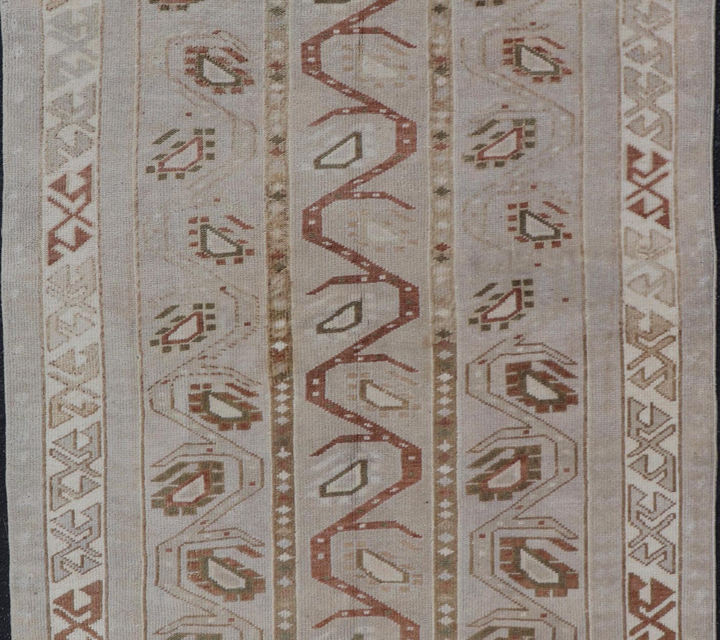 Measures: 3'5 x 6'2 This one - of - a - kind Turkish Oushak has a light taupe colored background reaching the field and the border. The unique tribal designs within the field are rendered in brick red, brown, and forest green. The complimentary borde... - Keivan Woven ArtsTU - MTU - 6003 - 19034