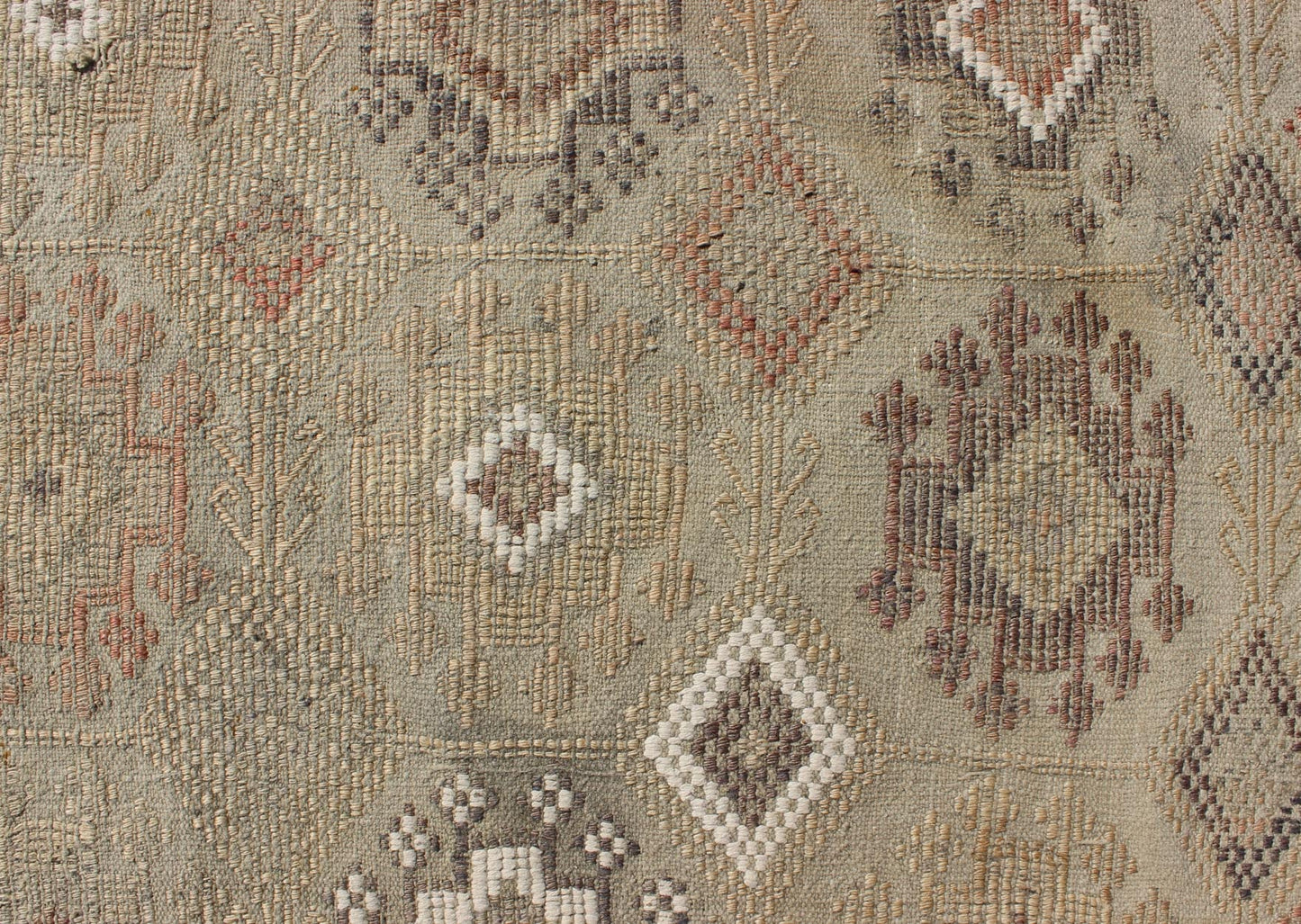 Vintage Turkish Kilim Featuring Muted Colors and All - Over Tribal Motif Design Measures 4'7 x 8'0 This rug features an asymmetrical design of tribal crests decorating the light blue - grey field. The crests are rendered in varying muted shades ... - Keivan Woven ArtsTU - NED - 136032 - 4618Rug