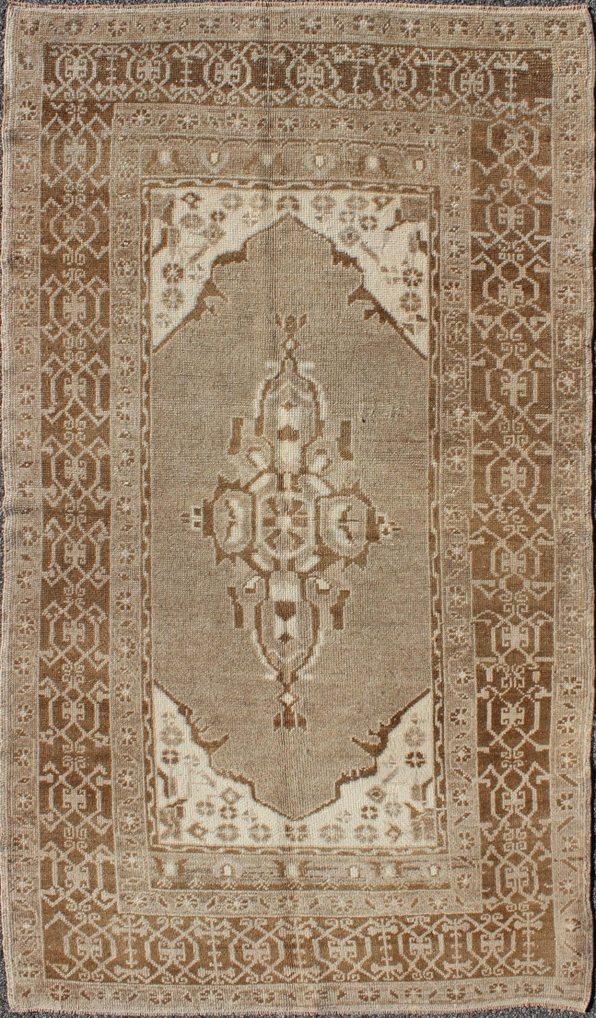Vintage Turkish Medallion Oushak Area Rug in Grey and Brown's Measures: 3.10 x 6.10 Set amidst a taupe and gray background and featuring a gentle medallion, the beautiful and delicate design of this rug is framed by repeating geometric el... - Keivan Woven ArtsTU - TRS - 95020 - 3582Rug