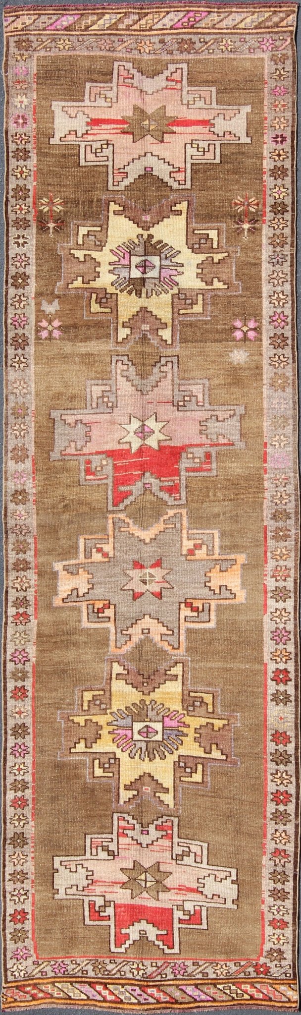 Unique & Colorful Turkish Kars Runner with Tribal Designs and Geometric Motifs Vintage Turkish runner in greenish Brown background, ivory border with accent colors, red, pink, tan, green, bright yellow, taupe, rug/TU - UGU - 4806, country of origin... - Keivan Woven ArtsTU - UGU - 4806 - 10287Rug