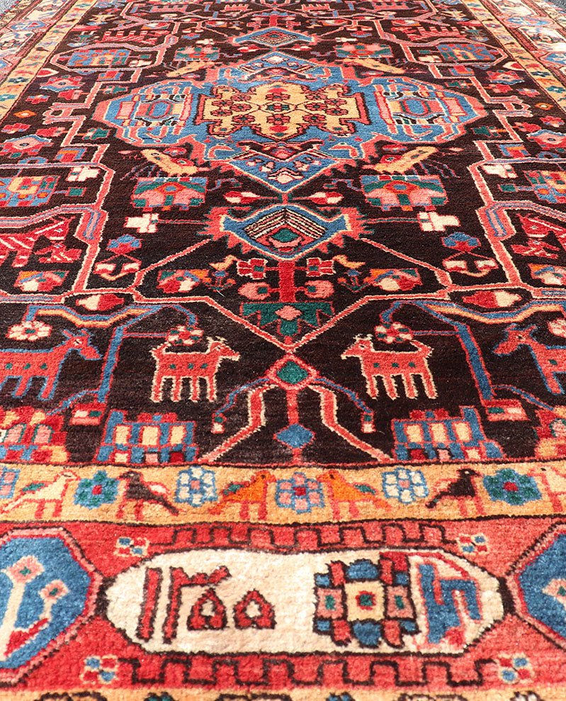 Antique Persian Nahavand Rug with All - Over Sub - Geometric Tribal Design Measures: 4'3 x 9'4. This absolutely stunning Antique Nahavand (circa 1920s) features a symmetrical sub - geometric design rendered in shades of reds, blues, greens, cre... - Keivan Woven ArtsV21 - 1103 - 18341
