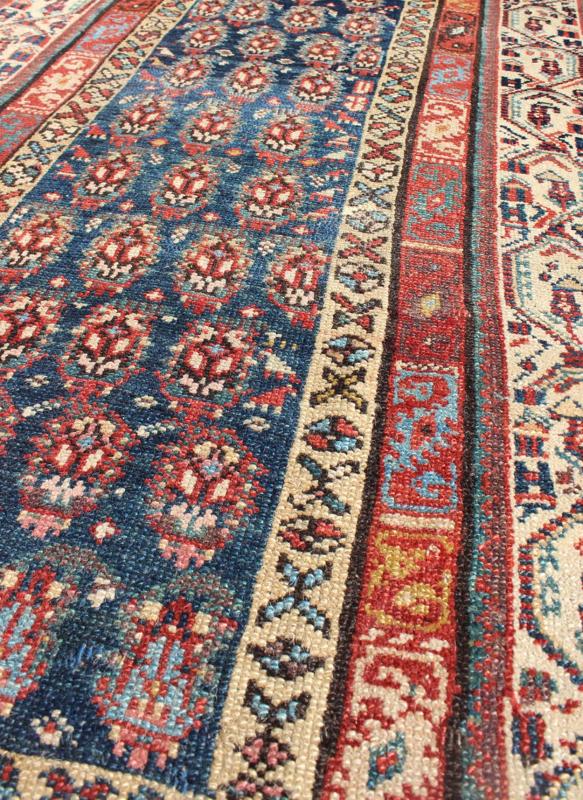 Long Antique Persian Runner - This antique runner was woven in far northwest Persia in the area bordering the Caucasus. The deep madder red color and saturation of its finely drawn elements are enhanced by their placement against a deep indigo field. Th... - Keivan Woven ArtsZBH - 15053 - 8006Rug