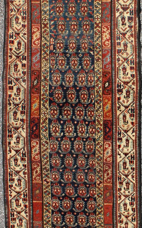 Long Antique Persian Runner - This antique runner was woven in far northwest Persia in the area bordering the Caucasus. The deep madder red color and saturation of its finely drawn elements are enhanced by their placement against a deep indigo field. Th... - Keivan Woven ArtsZBH - 15053 - 8006Rug