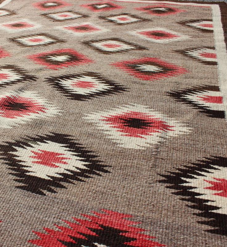American Navajo Rug with Geometric All - Over Design in Reds and Browns Measures: 3'0'' x 4'10''. This intriguing vintage Navajo rug was woven in the United States during the first half of the 20th century. The exciting and unique composition b... - Keivan Woven Arts16 - 0908 - 7775Rug
