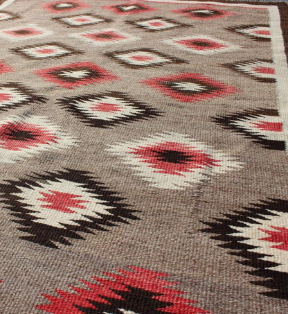 American Navajo Rug with Geometric All - Over Design in Reds and Browns Measures: 3'0'' x 4'10''. This intriguing vintage Navajo rug was woven in the United States during the first half of the 20th century. The exciting and unique composition b... - Keivan Woven Arts16 - 0908 - 7775Rug