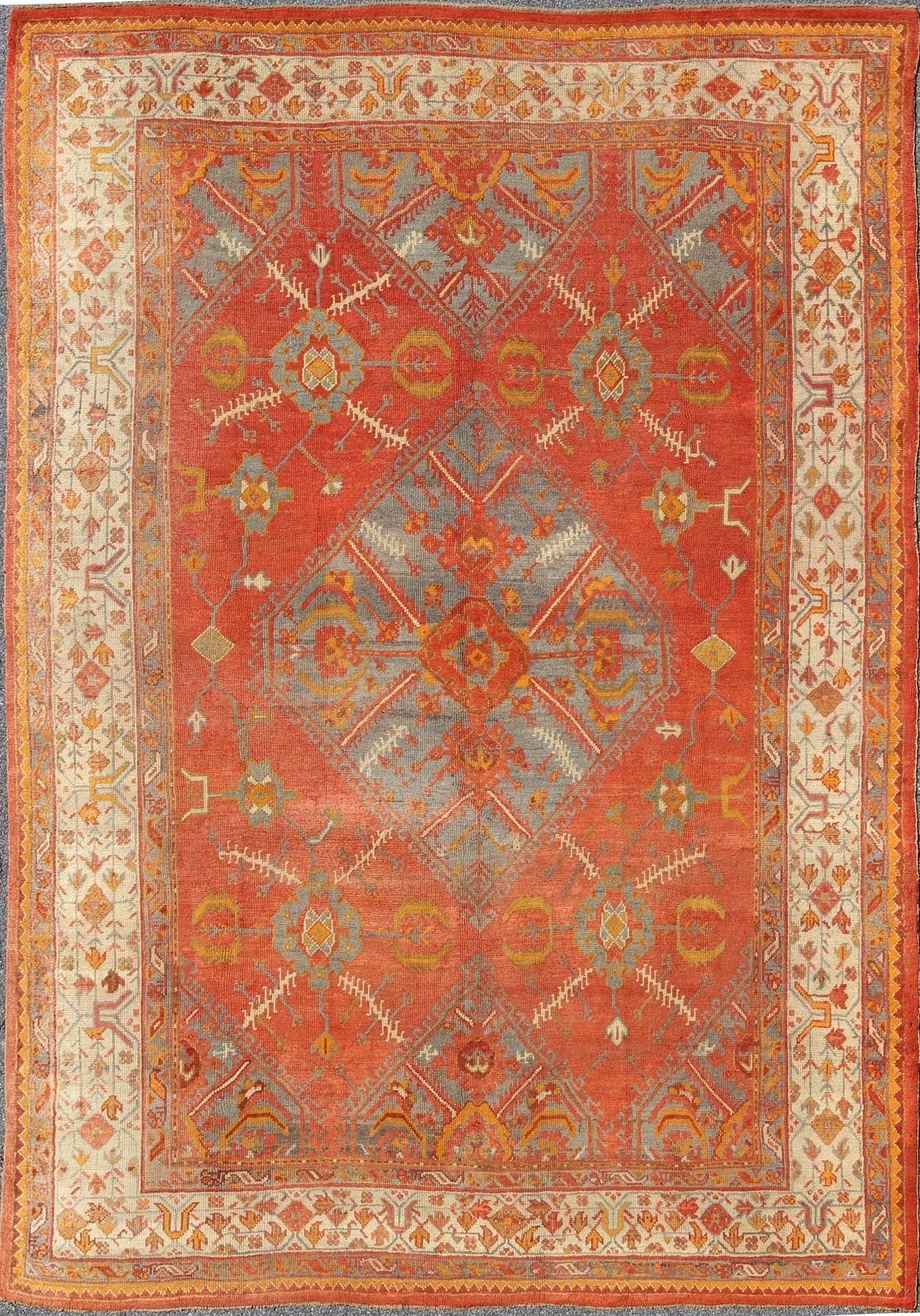 Antique Turkish Oushak rug with tribal Medallion design in terracotta, light gray blue, ivory and gold. Keivan Woven Arts / rug 16 - 0911, country of origin / type: Turkey / Oushak, circa 1900 Measures: 10' x 13'8. This antique Turkish Oushak carpe... - Keivan Woven Arts16 - 0911 - 8678Rug