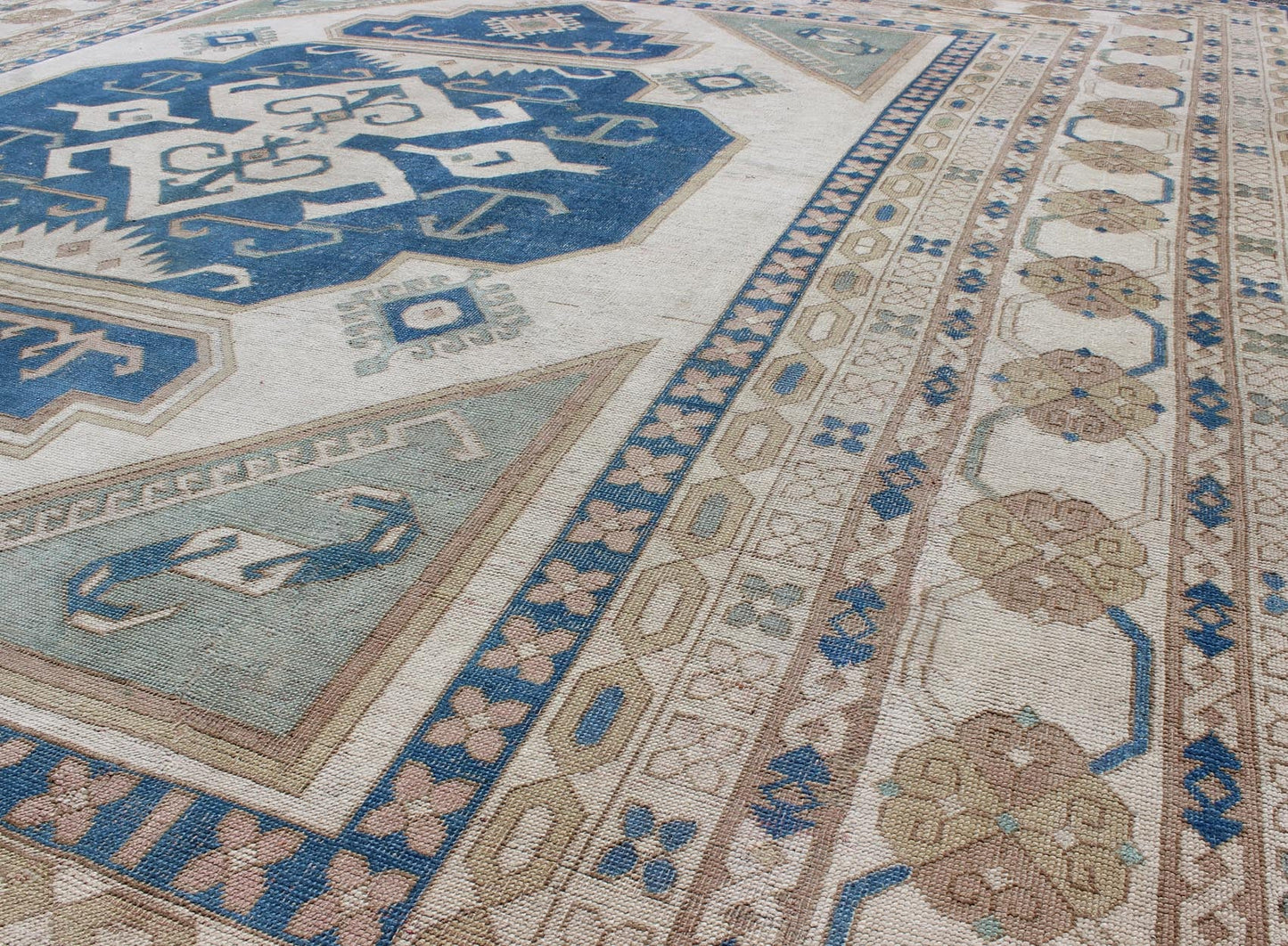 Large vintage Turkish rug with stylized geometric design in blue, ivory, tan. Keivan Woven Arts / rug 16 - 0914, country of origin / type: Turkey / Oushak, circa 1950 Measures: 13' x 15'8. This vintage Turkish Oushak rug features an intricately bea... - Keivan Woven Arts16 - 0914 - 8684Rug