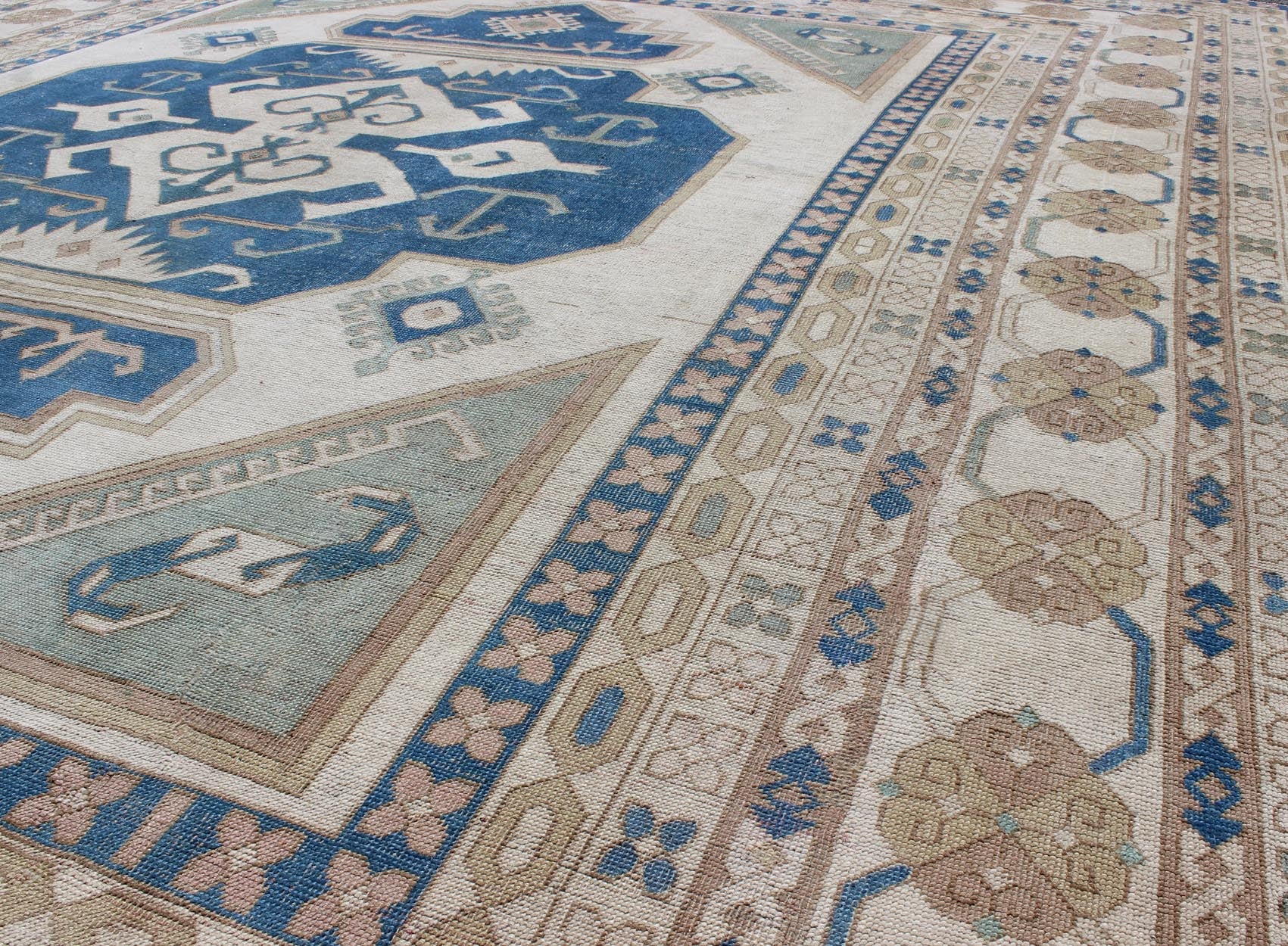 Large vintage Turkish rug with stylized geometric design in blue, ivory, tan. Keivan Woven Arts / rug 16 - 0914, country of origin / type: Turkey / Oushak, circa 1950 Measures: 13' x 15'8. This vintage Turkish Oushak rug features an intricately bea... - Keivan Woven Arts16 - 0914 - 8684Rug