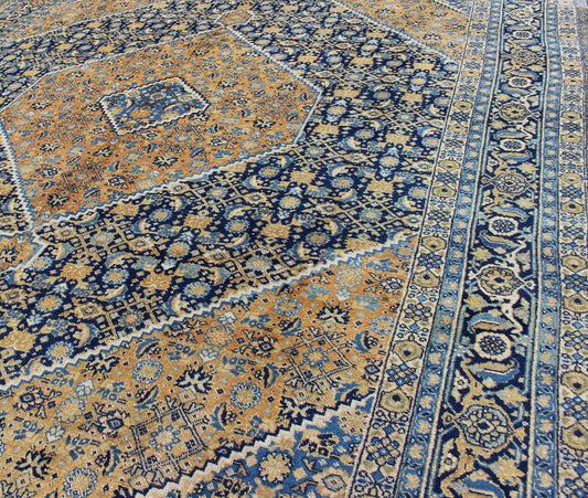 Antique Persian Tabriz Rug with Medallion And A Variety of Blue's and Gold's. Keivan Woven Arts / Rug / 16 - 1205, country of origin / type: Iran / Tabriz, circa 1920. Classic geometric Tabriz. Measures: 9'3 x 12'5. This antique Persian Tabriz rug ... - Keivan Woven Arts16 - 1205 - 8151Rug
