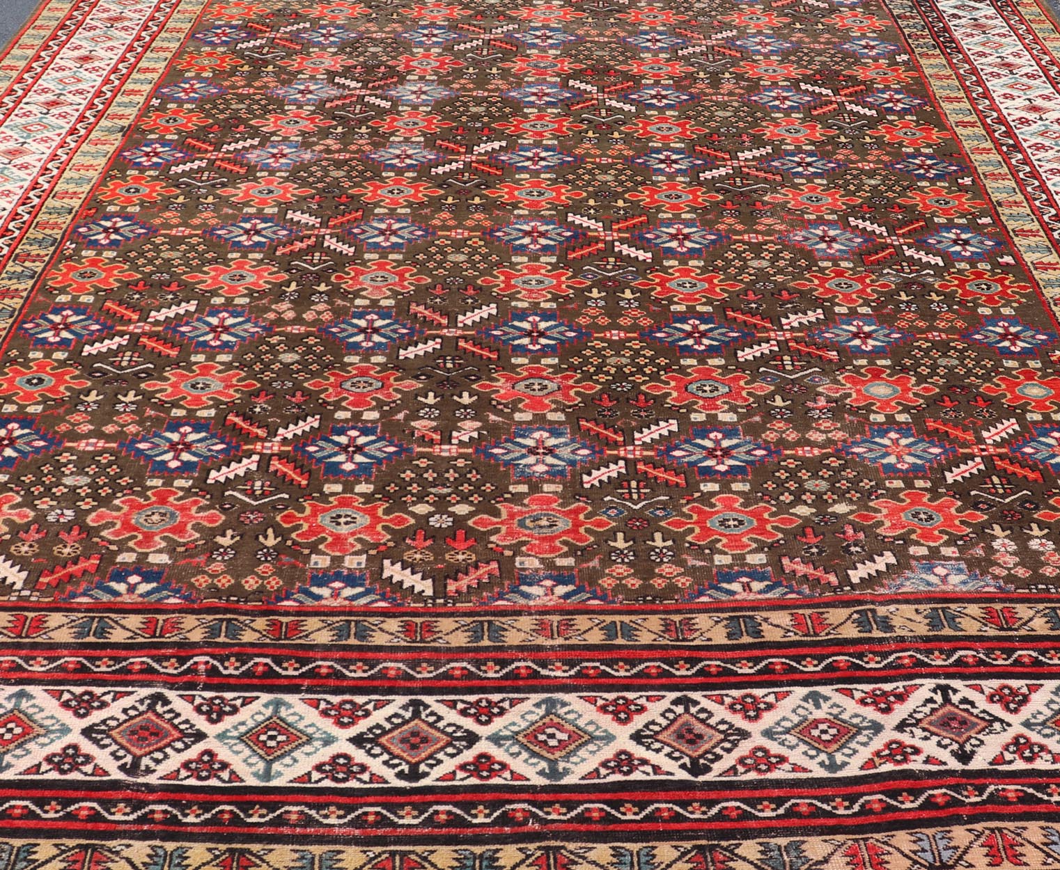 Antique Kurdish rug with brown, red, and blue geometric floral design. Keivan Woven Arts / rug 17 - 0201, country of origin / type: Iran / Kurdish, Early 19th Century, possible late 18th century. Measures: 12'3 x 17'6. This 19th century antique K... - Keivan Woven Arts17 - 0201 - 8205Rug
