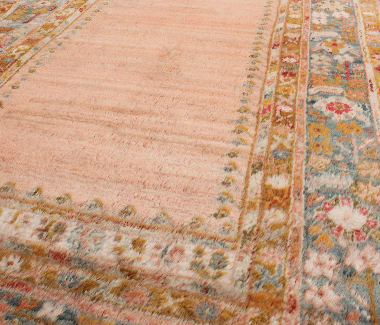 Antique Angora wool Oushak rug with empty salmon field and intricate borders, rug 17 - 0706, country of origin/type: Turkey/Oushak, circa 1900. This antique Turkish rug (circa 1900) features a relatively intricate and detailed border area and an a... - Keivan Woven Arts17 - 0706 - 8753Rug