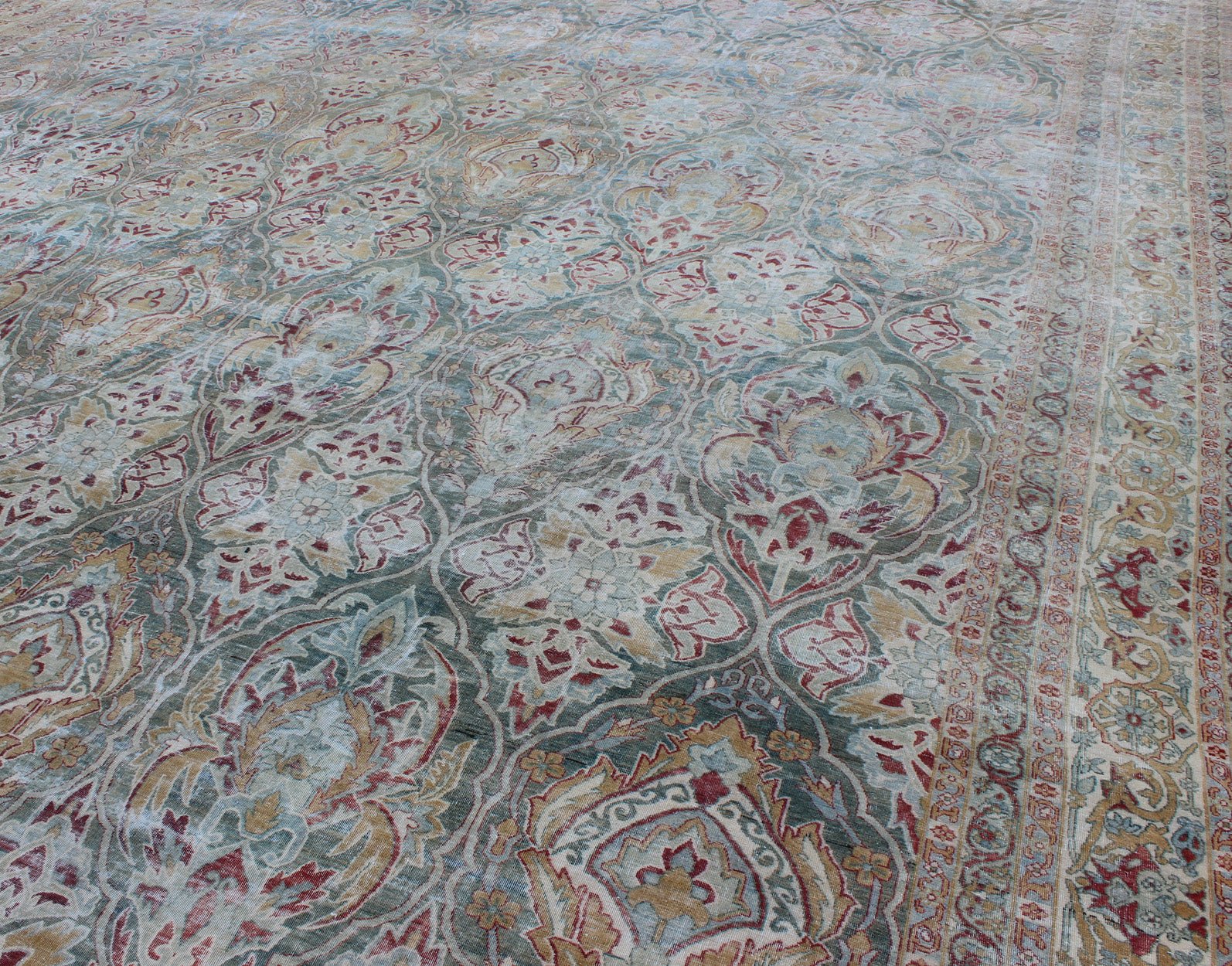 Very Large Antique Persian Distressed Lavar Kerman Rug In Large Scale Design. Very Large Antique finely woven Persian Lavar Kerman Rug In Large Scale Design. Large antique Persian Lavar Kerman distressed rug with large scale layered flowers in ... - Keivan Woven Arts17 - 1003 - 9232Rug