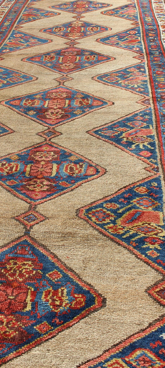 Colorful Long Antique Persian Serab Runner with Camel, Blue, Red and Brown The navy blue and camel field in this piece is decorated with multicolored strap work, lattice work and stylized Boteh and floral elements. Beautifully drawn ivory and bl... - Keivan Woven Arts20940 - 1438Rug