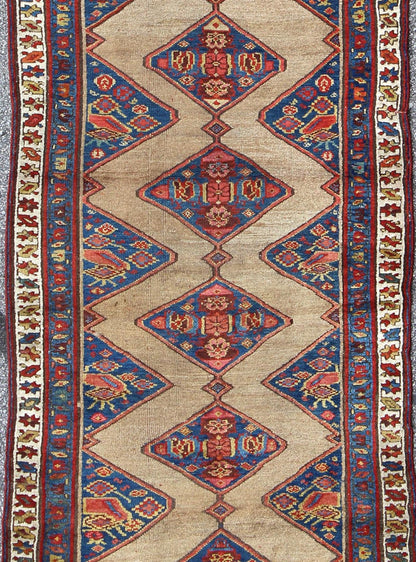 Colorful Long Antique Persian Serab Runner with Camel, Blue, Red and Brown The navy blue and camel field in this piece is decorated with multicolored strap work, lattice work and stylized Boteh and floral elements. Beautifully drawn ivory and bl... - Keivan Woven Arts20940 - 1438Rug
