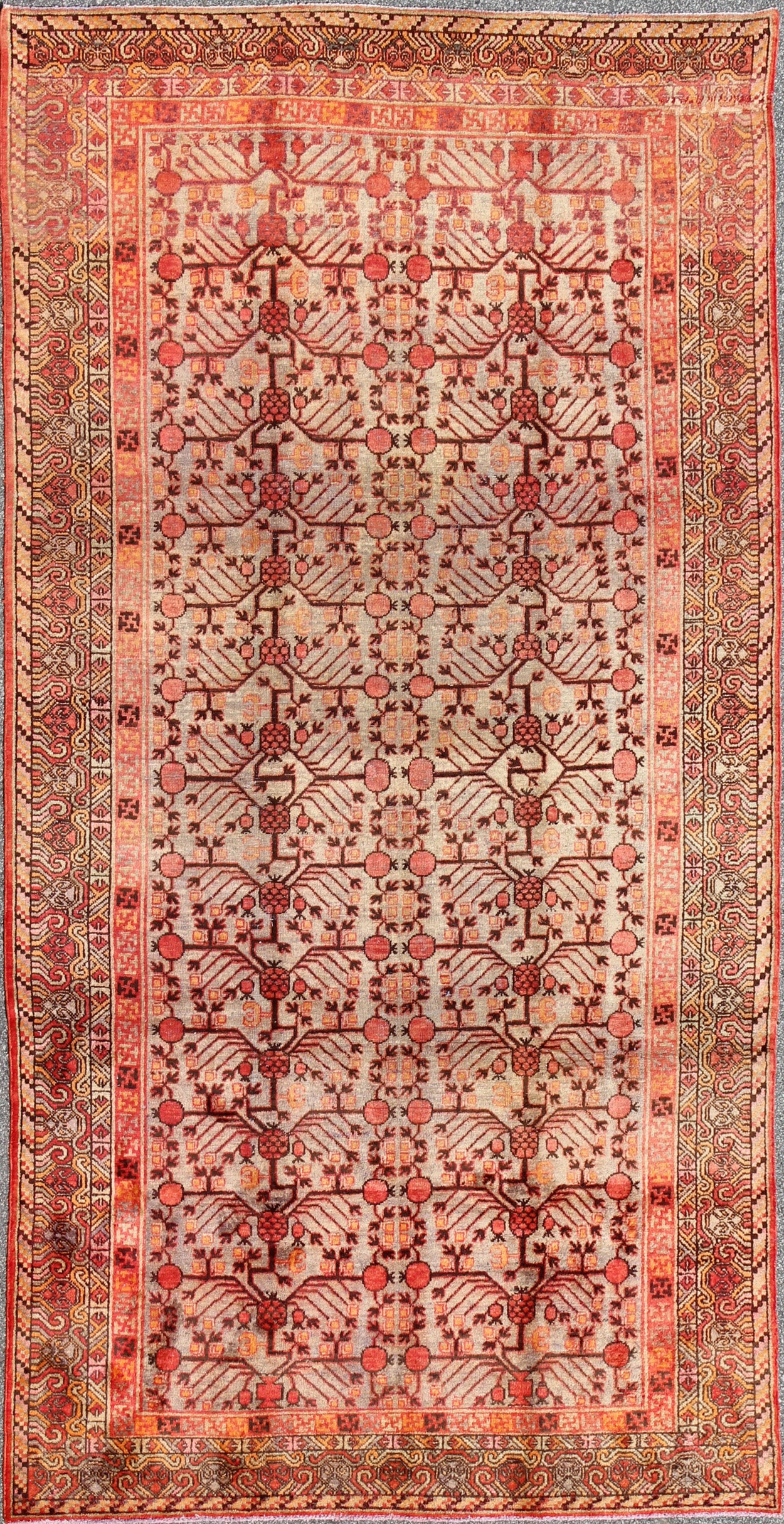 Antique Khotan Rug
 
 
 
 This attractive antique Khotan rug is a spectacular testament to the complexity of Turkestan design. The neutral tone of the central field plays host to a stunning display of the entwined tree of life bearing budding blossoms ...