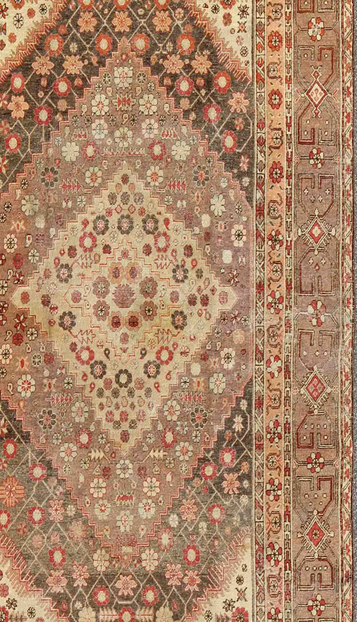 Antique Khotan Medallion Rug in Neutrals and Blush with Floral Motifs All-Over
 
 
 
 Measures: 6'4 x 11'6 
 
 
 
  This beautiful Khotan rug, from early 20th century Turkestan features layered medallions in geometric and diamond shapes. The field and ...