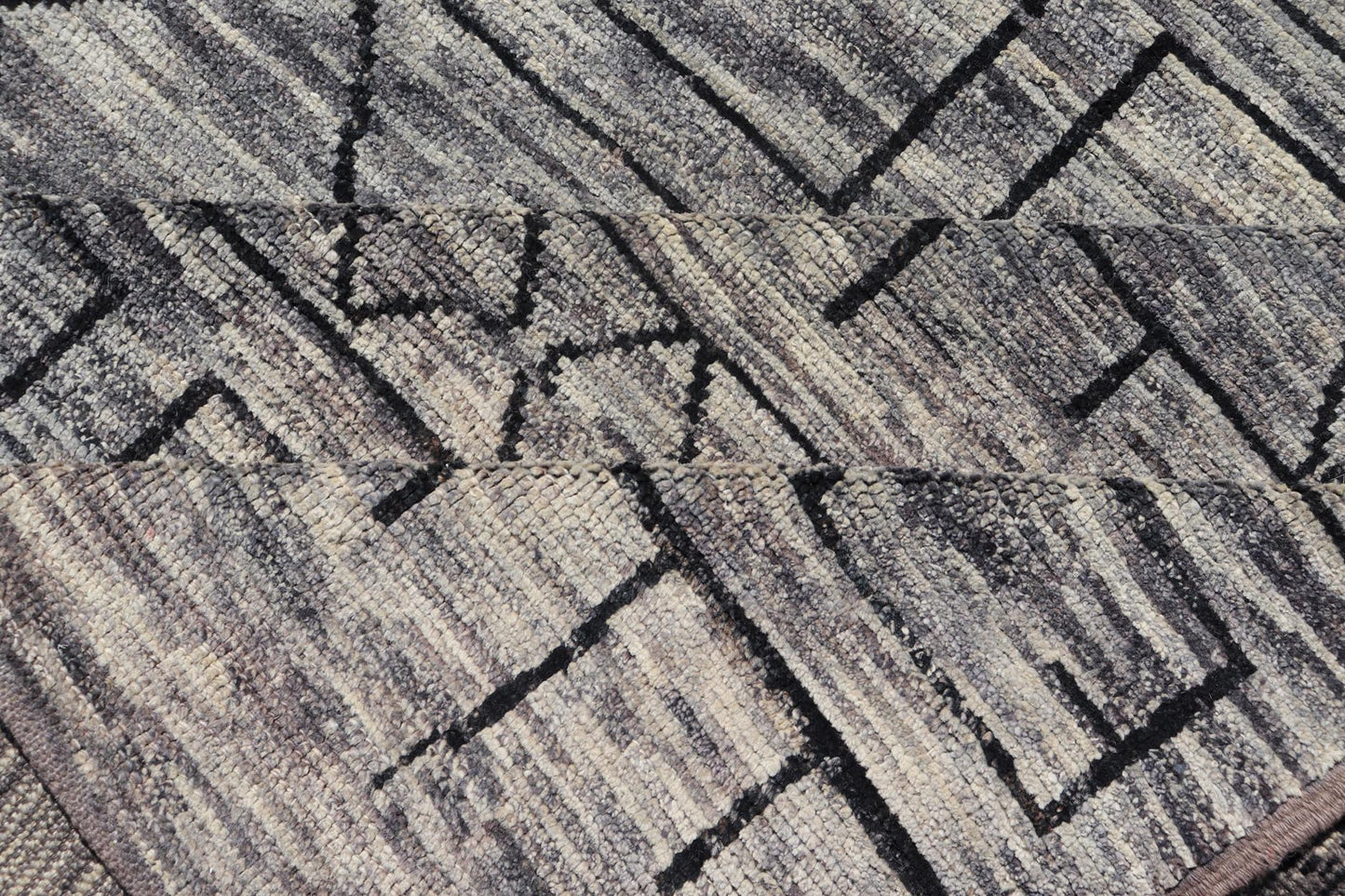 Modern Hand-Knotted Rug in Wool with Geometric Design in Black and Gray Tones
 
 
 
 This modern casual tribal rug has been hand-knotted. The rug features a modern geometric design, replete with various shapes rendered in black and gray tones; making t...