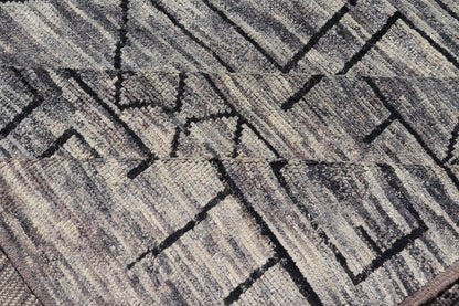 Modern Hand-Knotted Rug in Wool with Geometric Design in Black and Gray Tones
 
 
 
 This modern casual tribal rug has been hand-knotted. The rug features a modern geometric design, replete with various shapes rendered in black and gray tones; making t...