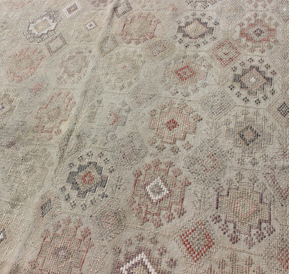 Vintage Turkish Kilim Featuring Muted Colors and All-Over Tribal Motif Design
 
 
 
 Measures 4'7 x 8'0 
 
 This rug features an asymmetrical design of tribal crests decorating the light blue-grey field. The crests are rendered in varying muted shades ...