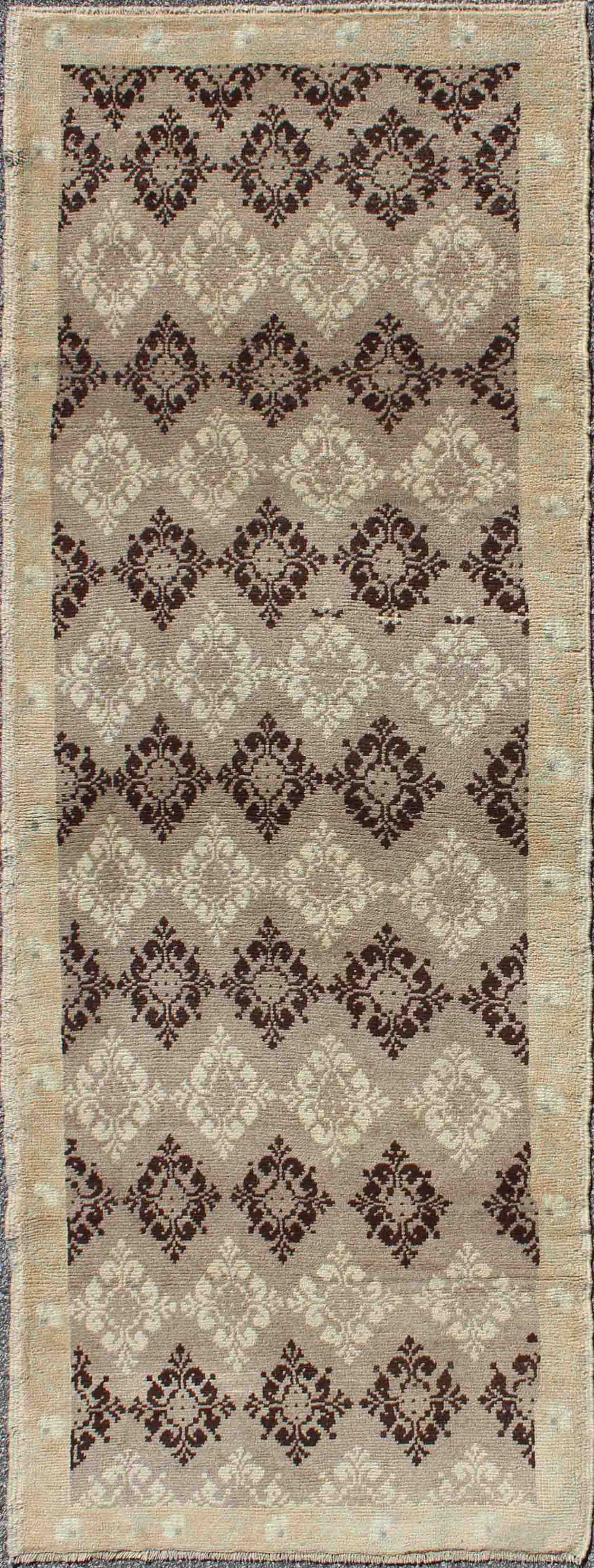 Taupe, brown, ivory vintage Turkish Oushak runner with diamond blossom motifs, rug en-1012, country of origin / type: Turkey / Oushak, circa 1940
 
 
 
 This unique Turkish Oushak carpet features an all-over design of intricate diamond-shaped botanical...