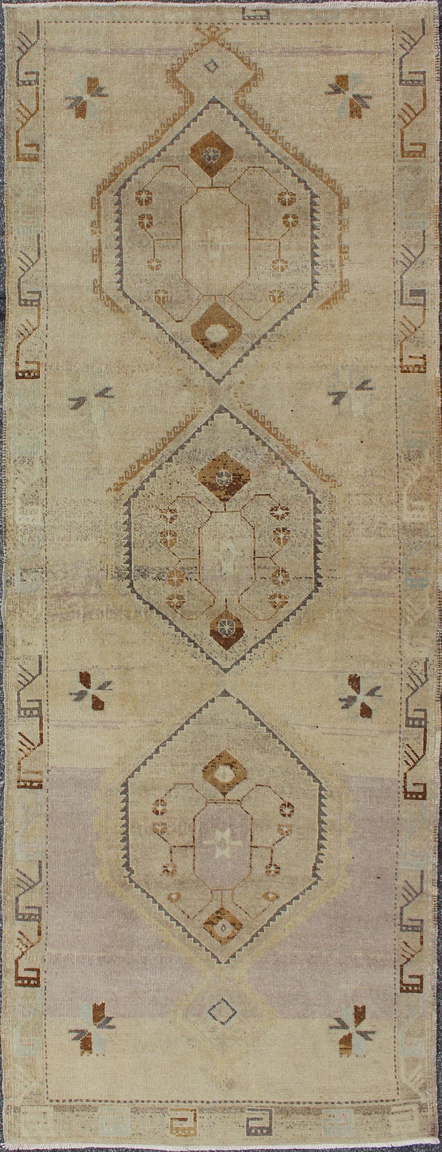 Vintage Turkish Oushak Runner with Tribal Medallions in Lavender, Taupe & Brown
 
 
 
 This vintage Turkish Oushak gallery rug (circa mid-20th century) features a unique blend of colors and an intricately beautiful design. The central medallions consis...