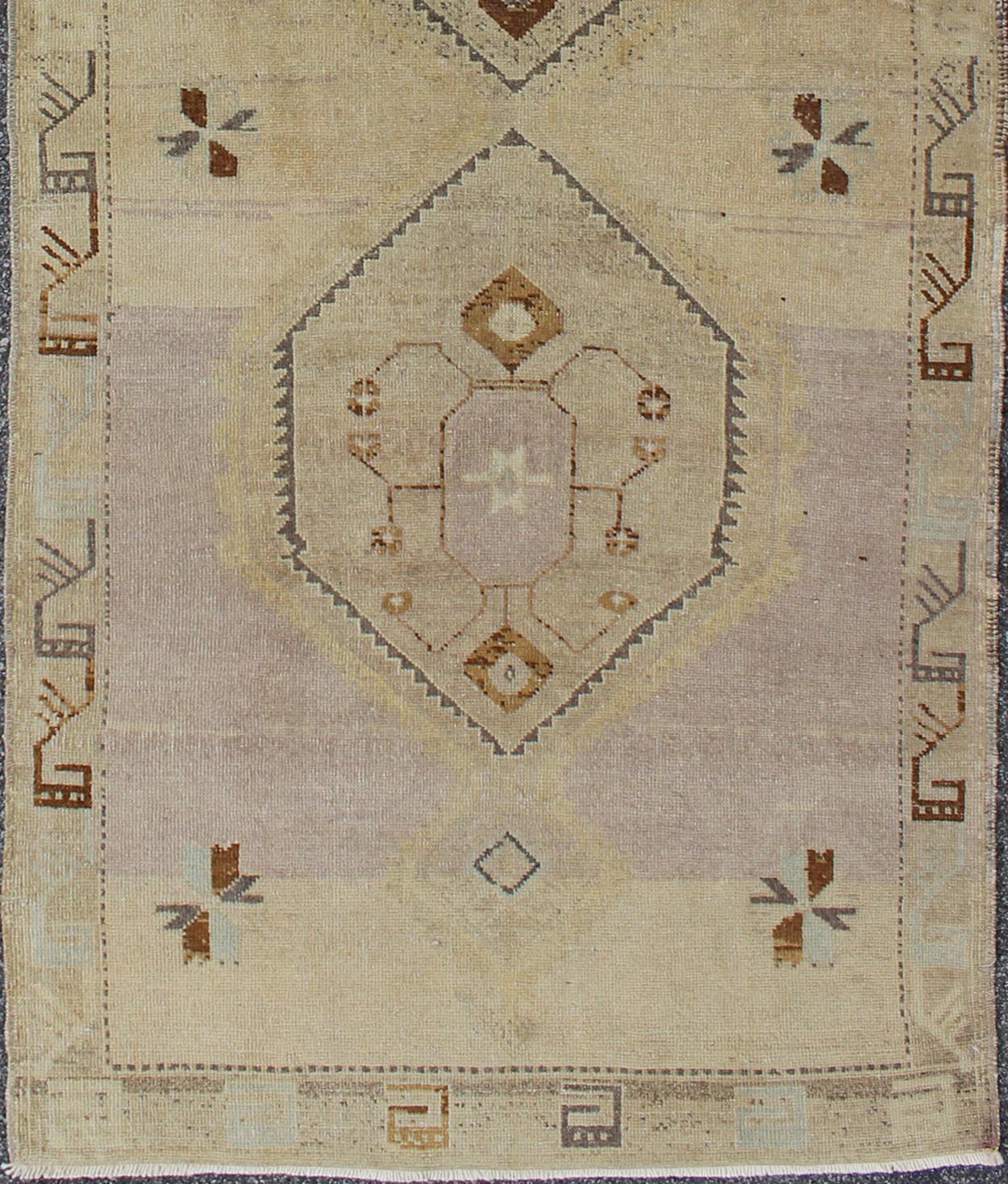 Vintage Turkish Oushak Runner with Tribal Medallions in Lavender, Taupe & Brown
 
 
 
 This vintage Turkish Oushak gallery rug (circa mid-20th century) features a unique blend of colors and an intricately beautiful design. The central medallions consis...