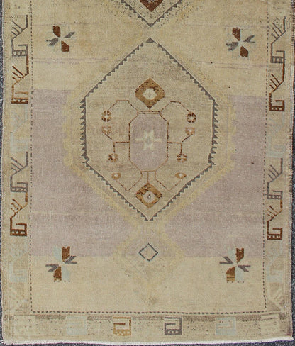 Vintage Turkish Oushak Runner with Tribal Medallions in Lavender, Taupe & Brown
 
 
 
 This vintage Turkish Oushak gallery rug (circa mid-20th century) features a unique blend of colors and an intricately beautiful design. The central medallions consis...