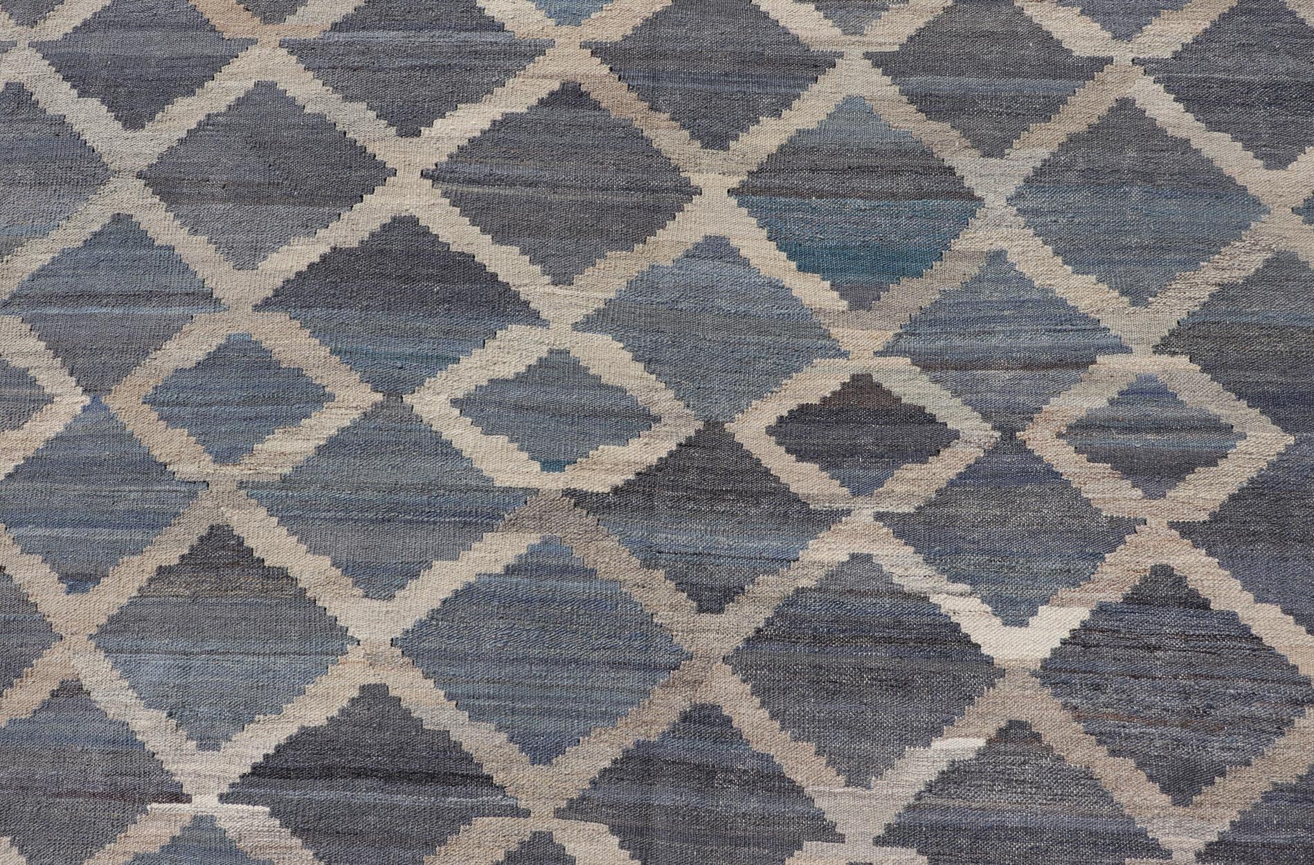 Modern Hand - Woven Kilim in Wool with Sub - Geometric Interlocked Diamond Design This modern flat - weave kilim has been hand - woven. The rug features a modern sub - geometric interlocked diamond design, rendered in blues, grays and cream; making this r... - Keivan Woven ArtsAFG - 037 - 19664Rug