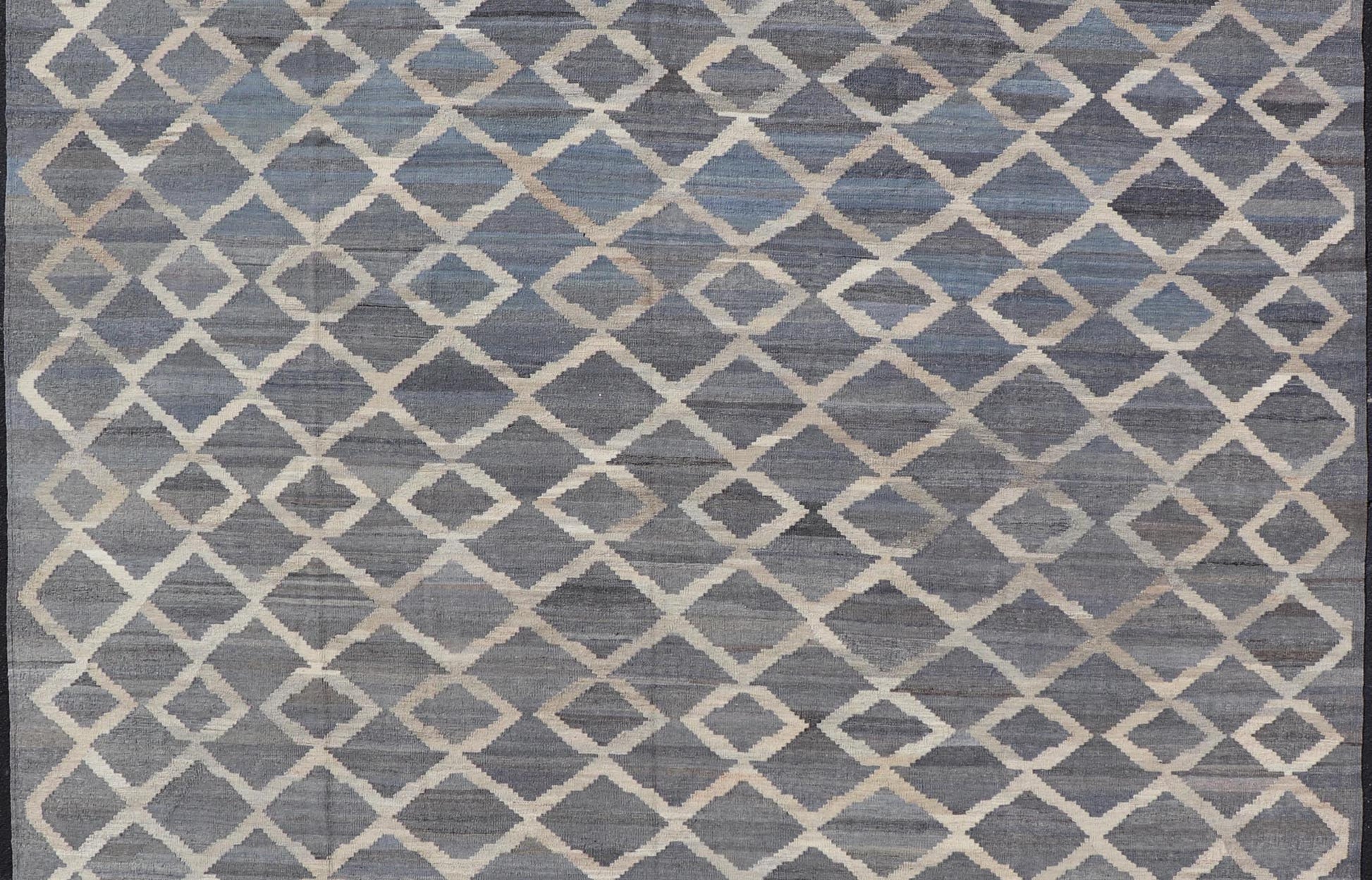 Modern Hand - Woven Kilim in Wool with Sub - Geometric Interlocked Diamond Design This modern flat - weave kilim has been hand - woven. The rug features a modern sub - geometric interlocked diamond design, rendered in blues, grays and cream; making this r... - Keivan Woven ArtsAFG - 037 - 19664Rug